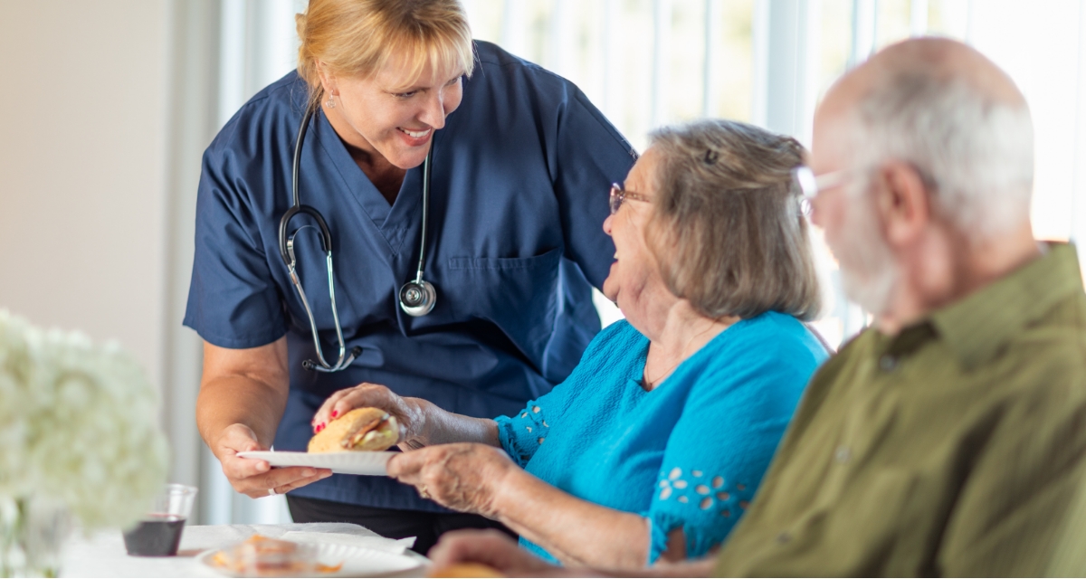 Carer with two elderly patients
