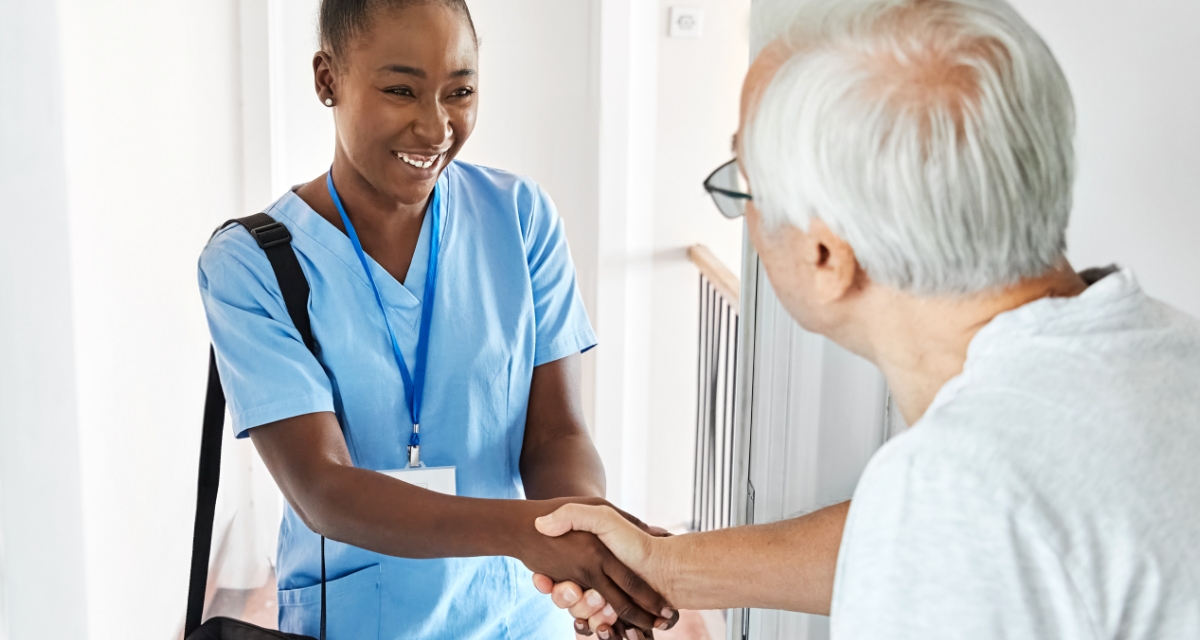 Carer greeting a client at the front door