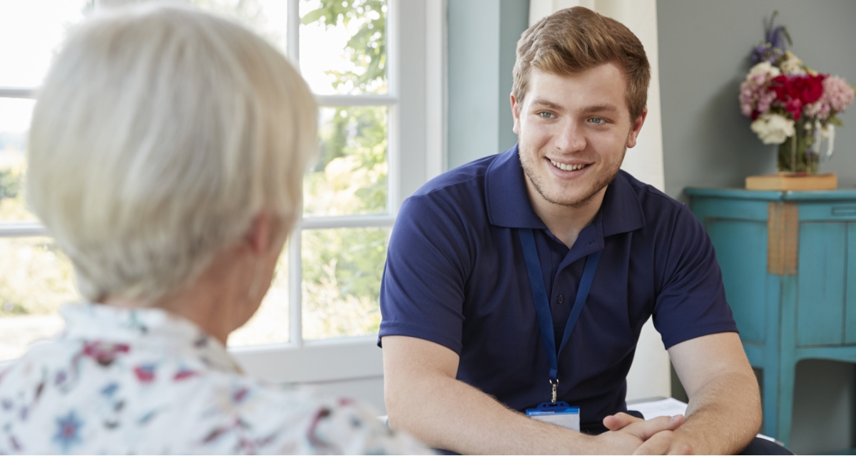 Professional carer speaking with a family member